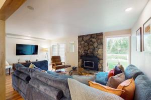 a living room with a large couch and a fireplace at Wister F in Teton Village