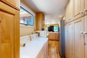 a kitchen with white appliances and wooden cabinets at Wister F in Teton Village +36 photos