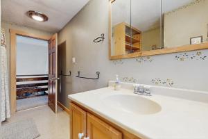 a bathroom with a sink and a mirror at Peaceful Home in North Conway +46 photos