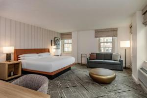 a hotel room with a bed and a couch at Sheraton Commander Hotel in Cambridge +54 photos