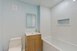 a white bathroom with a sink and a toilet at Sea Gold in Wells +60 photos