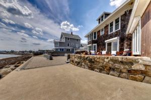 a large house with a stone wall next to the ocean at Sea Gold in Wells