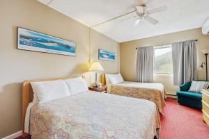 a hotel room with two beds and a couch at South Peak Condo at Rivergreen in Lincoln +108 photos