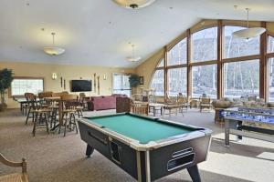a living room with a pool table and tables at South Peak Condo at Rivergreen in Lincoln