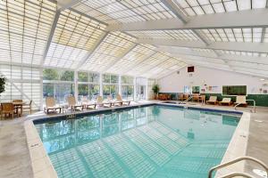a large swimming pool with a glass ceiling at South Peak Condo at Rivergreen in Lincoln