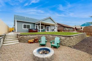 a backyard with two chairs and a fire pit at Modern Mountain View Escape in Columbia Falls