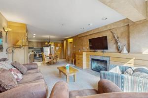 a living room with a couch and a fireplace at Shoshone 1919 in Big Sky