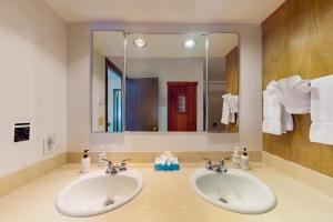 a bathroom with two sinks and a large mirror at Teton Shadows Darwin F in Jackson +31 photos