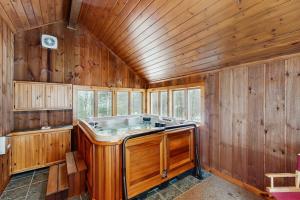 a large wooden tub in a room with wooden walls at Owls' Hollow in West Dover +44 photos