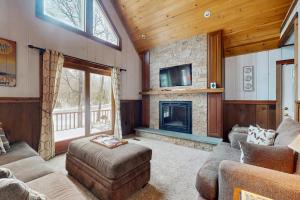 a living room with a couch and a fireplace at Owls' Hollow in West Dover