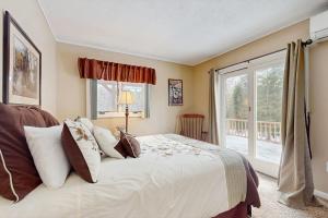 a bedroom with a large bed and a window at Owls' Hollow in West Dover