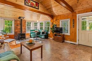 a living room with a couch and a table at Sebago Shores Cottage in North Sebago