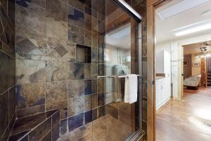 a bathroom with a shower with a glass door at Lone Walker Home in Big Sky +65 photos