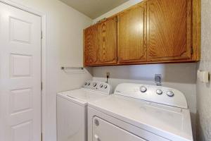 a small kitchen with a white washer and dryer at Golfer's Villa in Bigfork +43 photos