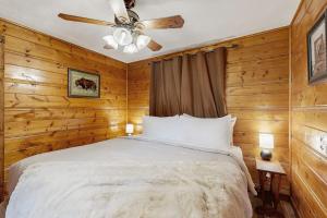 a bedroom with a bed and a ceiling fan at Bear Chalet in Bigfork