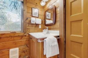 a bathroom with a sink and a mirror at Bear Chalet in Bigfork +20 photos