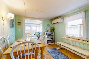 a dining room with a wooden table and chairs at The Eastern Avenue Cottage in Wells Beach