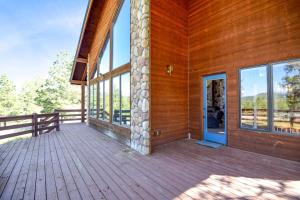 an empty porch of a wooden house with a door at Wren Ridge in Pagosa Springs