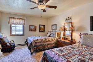 a bedroom with two beds and a ceiling fan at South Fork Sunset in South Fork