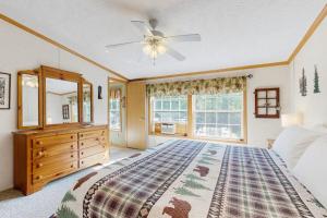 a bedroom with a large bed and a ceiling fan at Hillside Hideaway in North Woodstock