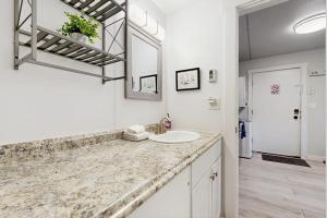 a white bathroom with a sink and a mirror at Mountain View Escape in Big Sky +36 photos