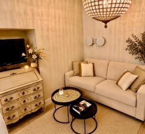 a living room with a couch and a tv at Rossetti in Nice
