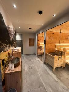 a bathroom with a sink and a tub at Gasthof Venedigerblick in Neukirchen am Großvenediger +38 photos