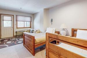 a bedroom with two bunk beds and a couch at Locke Mountain A6 in Newry