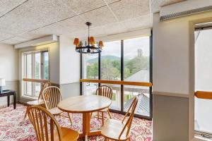 a dining room with a table and chairs and windows at South Peak Efficiency At Rivergreen in Lincoln