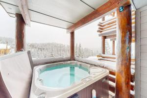 a jacuzzi tub in the middle of a balcony at Saddle Ridge B2 in Big Sky