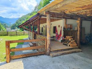 a wooden house with a porch and a fence at River Haus in Călineşti