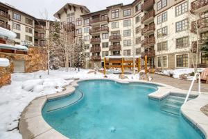 a swimming pool in the snow at a apartment complex at Passage Point 422 in Copper Mountain