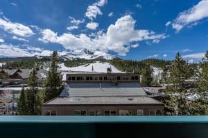a building with a snow covered mountain in the background at Shoshone 1960 in Big Sky