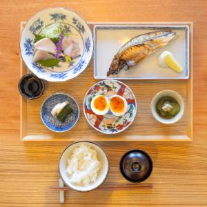 a table with plates of food and bowls of food at AKAMA Toyama in Shimminato +17 photos