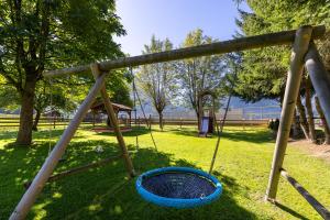 a swing in a park with a blue basket at Gasthof Venedigerblick in Neukirchen am Großvenediger