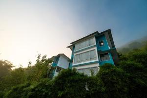a blue and white building on top of a hill at The Cloud by Daan in Vagamon +28 photos