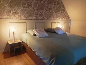 a bedroom with a bed with two pillows on it at Bienvenue à Longère Bihan - Chambres d'Hôtes - Bed & Breakfast in Plévin