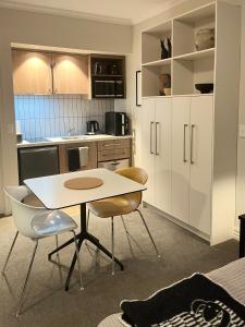 a kitchen with a table and chairs in a room at Studio 18 Cardrona in Cardrona
