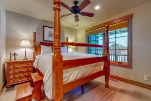 a bedroom with a wooden bed and a ceiling fan at Teton View Cabin in Jackson