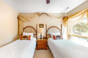 two twin beds in a room with a window at 4412 Mackinaw in Wilson