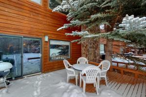 a table and chairs on a porch in the snow at Moran B in Jackson