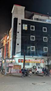 a building on a city street at night at Hotel sunshine in Kānpur