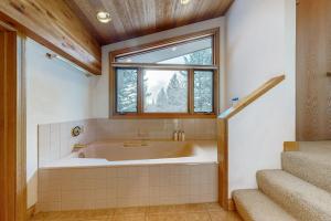 a bath tub in a bathroom with a window at The Clymer House in Teton Village +73 photos