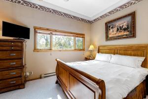 a bedroom with a bed with a television and a dresser at 5123 Foxtail in Wilson