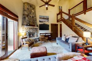 a living room with a couch and a fireplace at The Pines 206 in Steamboat Springs