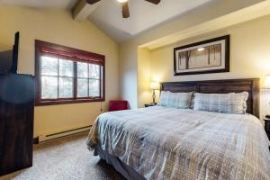 a bedroom with a large bed and a window at The Pines 206 in Steamboat Springs