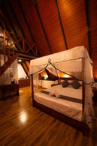 a bedroom with a canopy bed in a room at Haven Crest Sinharaja in Deniyaya +28 photos