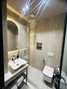 a bathroom with a sink and a toilet at Hotel Shopi Residence in Elbasan