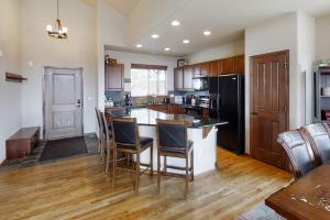 a large kitchen with a island with chairs in it at Deer Track Retreat in Granby