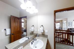 a bathroom with a sink and a large mirror at Deer Track Retreat in Granby +45 photos